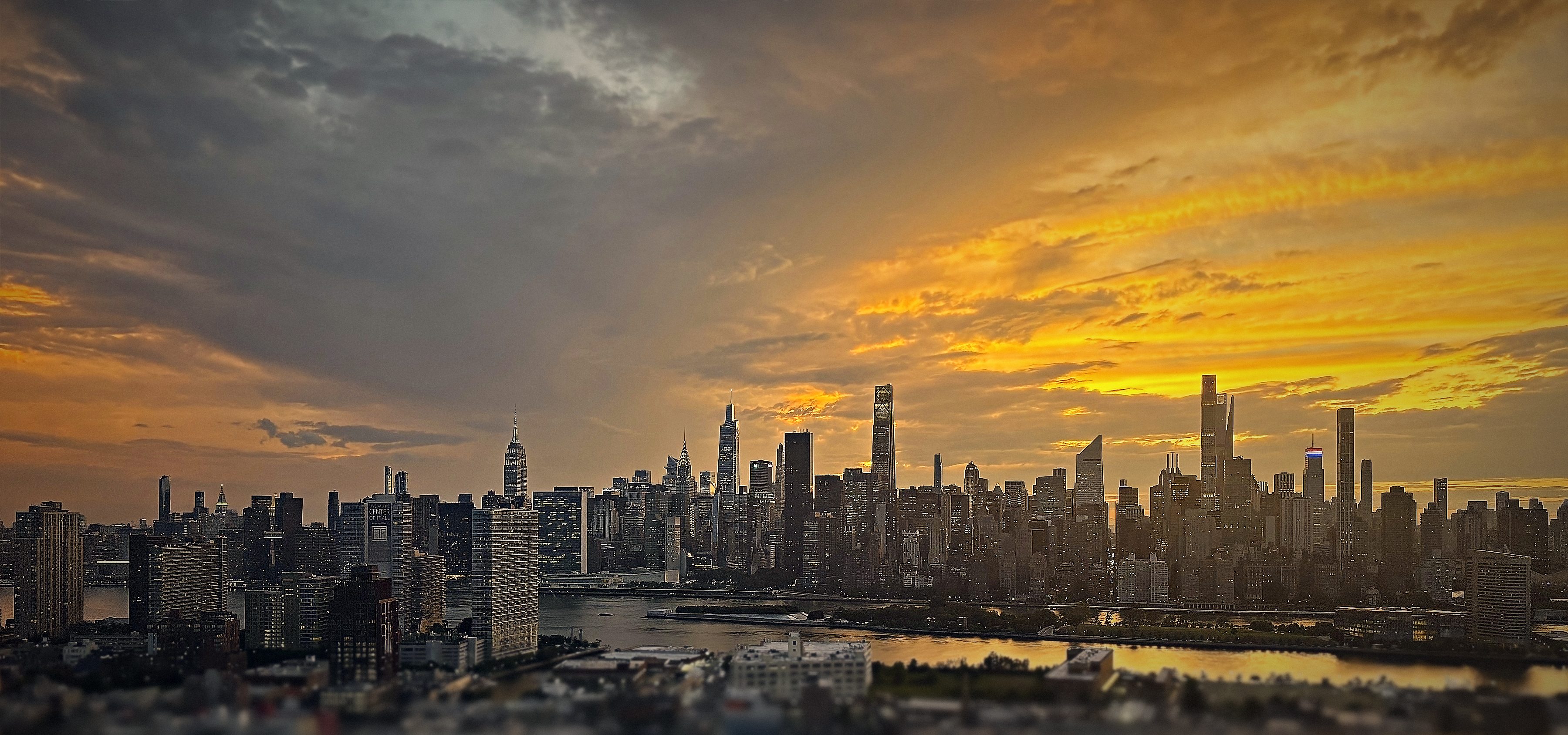 The Manhattan skyline at sunset, seen across the East River.